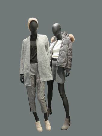 Two full-length female mannequins dressed in warm clothes, isolated. No brand names or copyright objects.の写真素材
