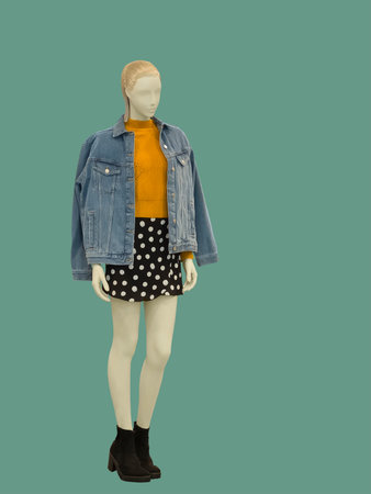 Full-length female mannequin dressed in casual clothes, isolated on green background. No brand names or copyright objects.の写真素材
