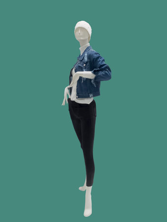Full-length female mannequin dressed in casual clothes, isolated on green background. No brand names or copyright objects.の写真素材