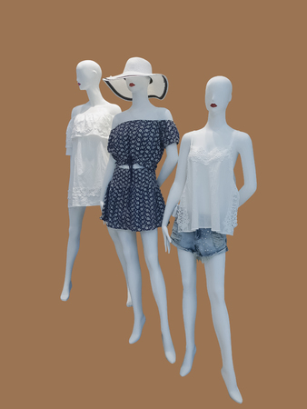 Three female mannequins dressed in fashionable clothes, isolated. No brand names or copyright objects.の写真素材