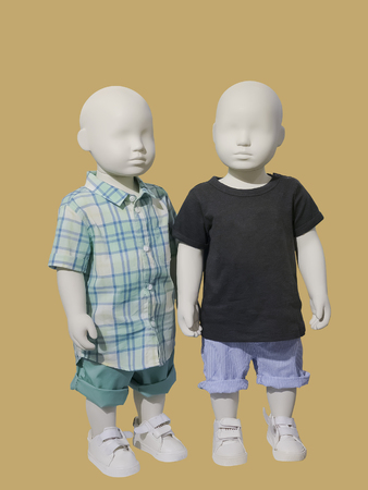 Two children mannequins dressed in casual kids wear, isolated. No brand names or copyright objects.の写真素材