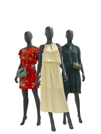 Three female mannequins dressed in fashionable clothes over white background. No brand names or copyright objectsの写真素材