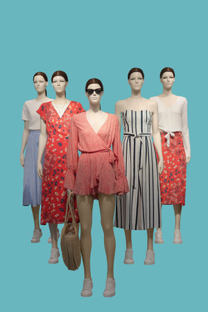 Group of female mannequins wear fashionable clothes, isolated. No brand names or copyright objects.