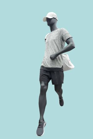 Running male mannequin isolated on blue background. No brand names or copyright objects.の写真素材