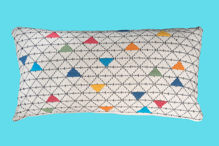 Decorative colorful throw pillow.  Isolated on blue background.
