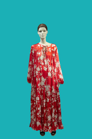 Full length female mannequin dressed in fashionable clothes, isolated on blue background. No brand...