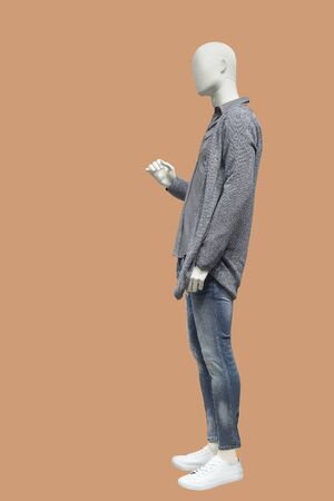 Full length male mannequin dressed in gray knitted jacket and blue jeans, isolated. No brand names or copyright objects.の写真素材
