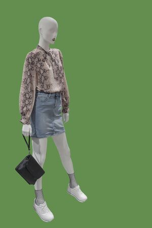Full length female mannequin dressed in casual clothes, isolated on green background. No brand names or copyright objects.の写真素材