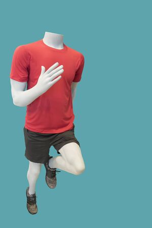 Running male mannequin, isolated on green background. No brand names or copyright objects.の写真素材