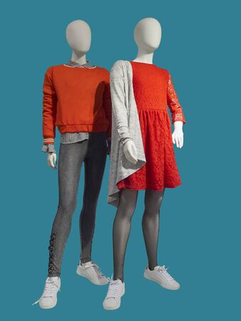 Two full length female mannequins wear clothes for teenagers, isolated. No brand names or copyright objects.の写真素材