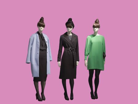 Three female mannequins dressed in fashionable clothes, isolated. No brand names or copyright objects.の写真素材