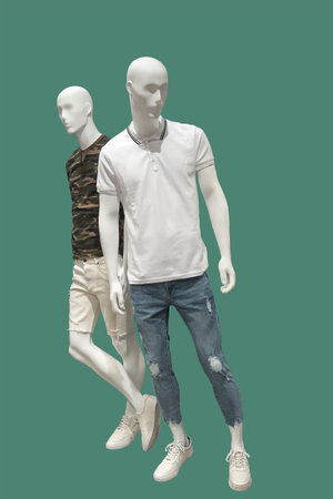 Two full length male mannequins dressed in summer casual clothes, isolated on green background. No brand names or copyright objects.の写真素材