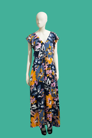 Full length female mannequin dressed in summer fashionable clothes, isolated on green background. No...