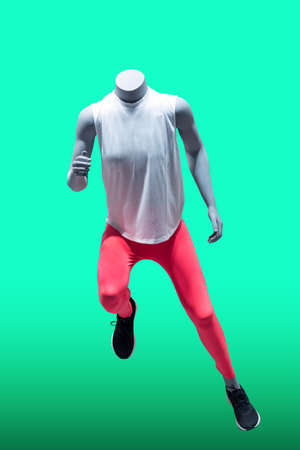 Running female mannequin, isolated on a green background. No brand names or copyright objects.の写真素材