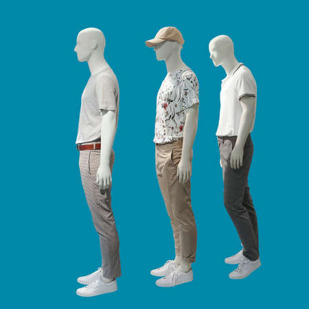 Three male mannequins dressed in casual clothes, isolated on blue background. No brand names or copyright objects.の写真素材