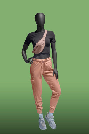 Full length female mannequin dressed in sportswear, isolated on green background. No brand names or copyright objects.の写真素材