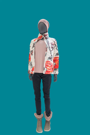 Full length image of a child display mannequin wearing warm fashionable clothes isolated on a blue backgroundの写真素材