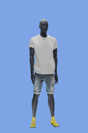 Full length image of a male display mannequin wearing white t-shirt and ripped jeans shorts isolated...
