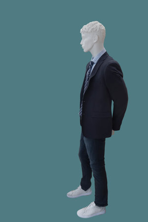 Full length image of a male display mannequin dressed in fashionable clothes isolated on a blue backgroundの写真素材