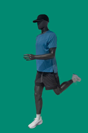 Full length image of a female display mannequin wearing fashionable clothes isolated on a blue background.の写真素材