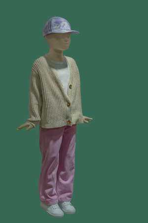 Full length image of a female display mannequin wearing fashionable clothes isolated on a blue background.の写真素材