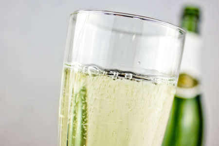 champagne with bottle in backgroundの写真素材
