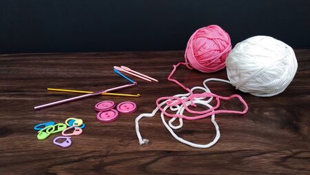 Pink and white yarn balls with crocheting accessoriesの写真素材