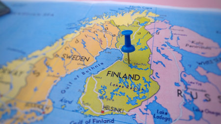 Blue Pushpin marking to Finland on travel map, travel concept