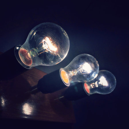 Three light bulbs in the darkの写真素材