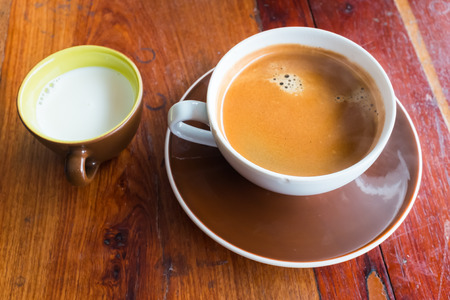 Espresso coffee in white coffee cup on old wooden tableの写真素材