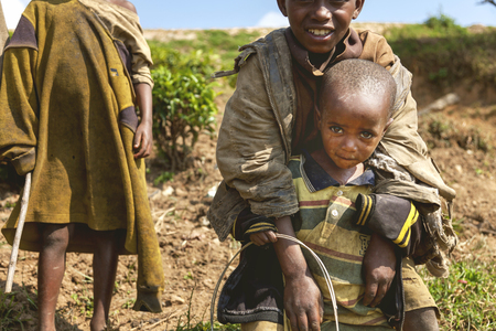 Ruhengeri, Rwanda - September 9, 2015: Unidentified children. The little child looking into the camera with beautiful and hopeful eyes.のeditorial素材