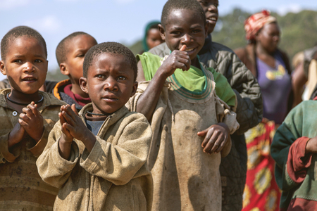 Ruhengeri, Rwanda - September 9, 2015: Unidentified children. The little children clapping the success of the strangers. They have excited smiles on their faces.のeditorial素材