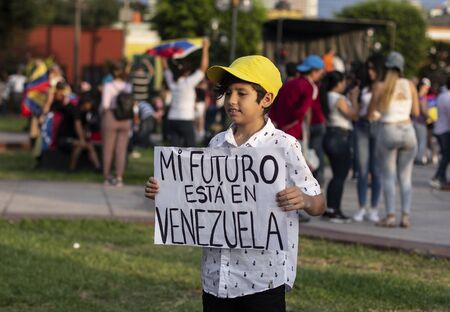Lima, Lima / Peru - February 2 2019: Adorable cute boy holding sign 'mi futuro esta en Venezuela' at protest against Nicolas Maduroのeditorial素材
