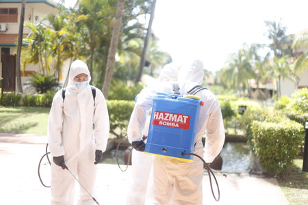 Teluk Kemang, Malaysia - April 24, 2020: Disaster Operation conducted by the Malaysian Fire and Rescue Department's Hazmat Special Forces at the Covid-19 Quarantine Interim Center in a hotel.のeditorial素材