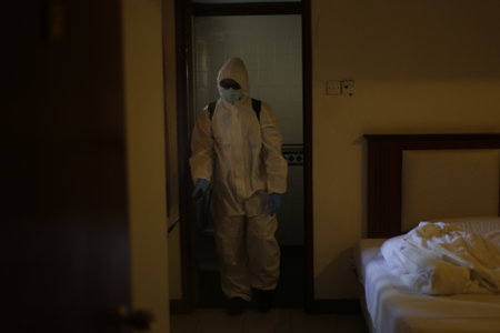 Teluk Kemang, Malaysia - April 24, 2020: Disaster Operation conducted by the Malaysian Fire and Rescue Department's Hazmat Special Forces at the Covid-19 Quarantine Interim Center in a hotel.のeditorial素材