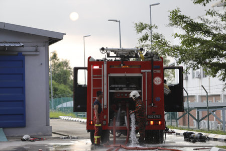 NILAI, MALAYSIA - 12 APRIL 2021: Malaysian firefighters try to put out a large fire that destroyed a...