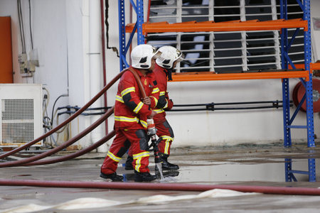 NILAI, MALAYSIA - 12 APRIL 2021: Malaysian firefighters try to put out a large fire that destroyed a...