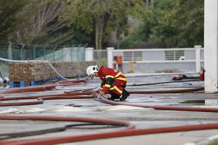 NILAI, MALAYSIA - 12 APRIL 2021: Malaysian firefighters try to put out a large fire that destroyed a...