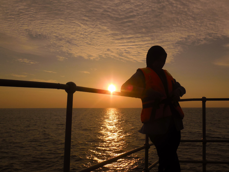 silhouette of people over the sunsetの写真素材