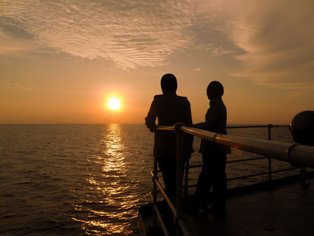 silhouette of people over the sunsetの写真素材