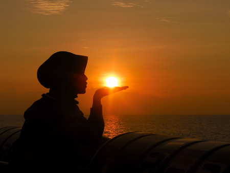 silhouette of people like to kissing sunの写真素材