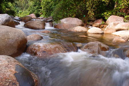 water flows through rocksの写真素材