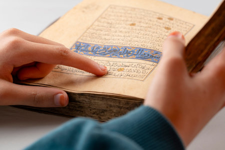 The holy book of the Koran in the hands of a Muslim woman