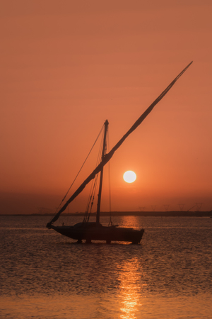 Sailboat and sunset in burullus lake Egyptの写真素材