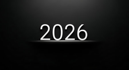 A stark, glowing white '2026' stands out against a deep black backdrop, illuminated by a soft, focused light.の素材