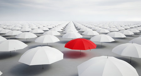 This image symbolizes individuality and standing out from the crowd, with one red umbrella contrasting against many white ones.の素材