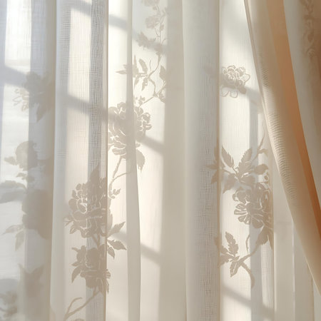 Gentle sunlight illuminates a sheer lace curtain with a subtle floral pattern, casting soft shadows and creating a peaceful ambiance.の素材