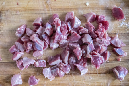 the fresh red pieces sheep meat was preparing in the kitchen by housewife