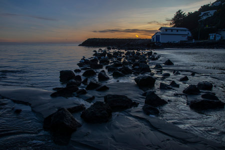 Sumner beach at Christchurch , New Zealand , where sun sets over pacific oceanの写真素材