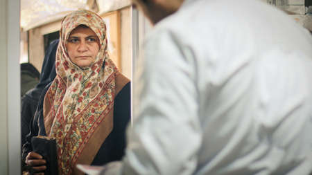 A sick elderly person talks with the doctor. Aleppo, Syria, February 19, 2020のeditorial素材